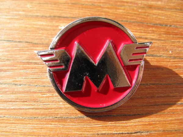 MATCHLESS ROUND WINGED METAL BADGE